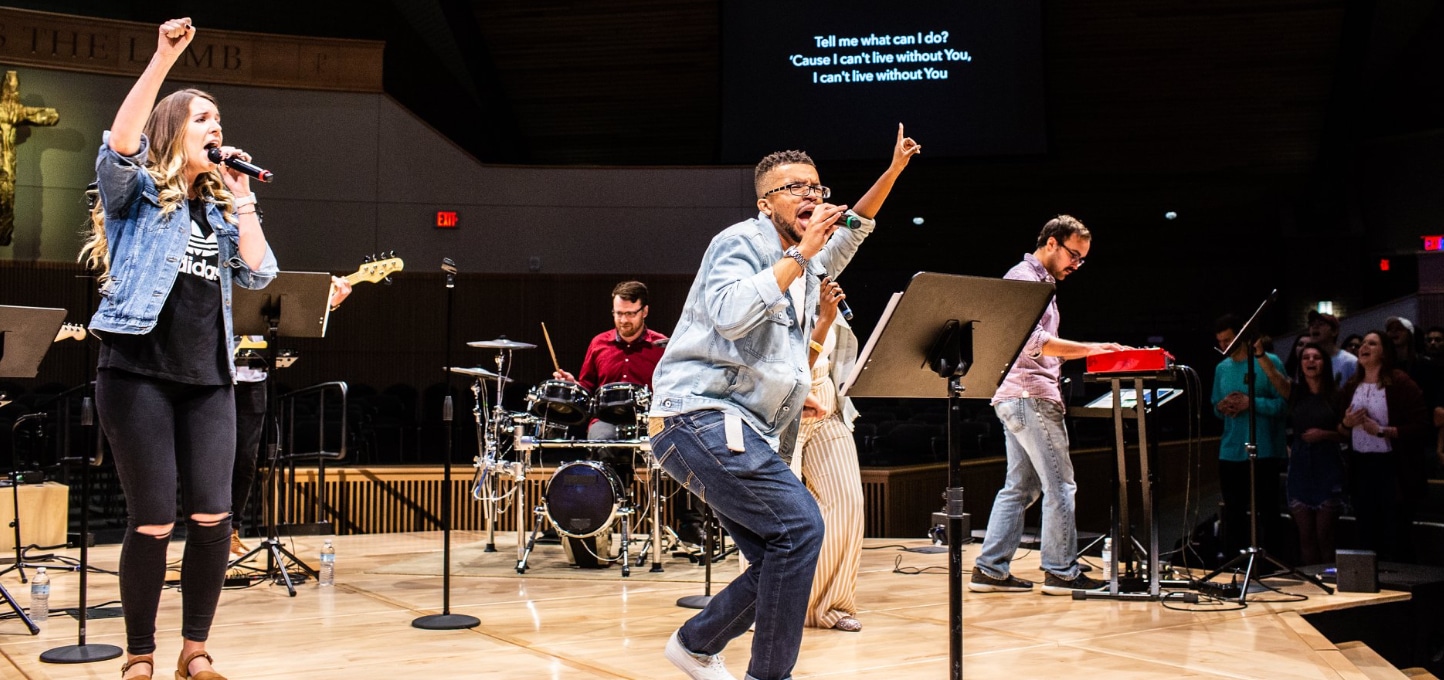 Students leading worship on the platform of Christ Chapel at Cornerstone University