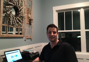 man sitting at laptop