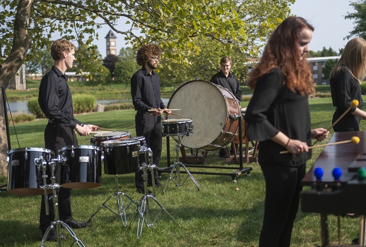 Percussion ensemble practicing outside on the campus of Cornerstone University