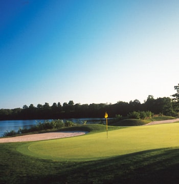Golf course with a lake in the background