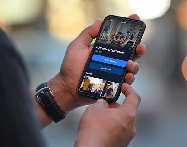 A person holding a smartphone displaying a course for 