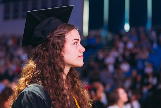 A graduate looks to her future during commencement.