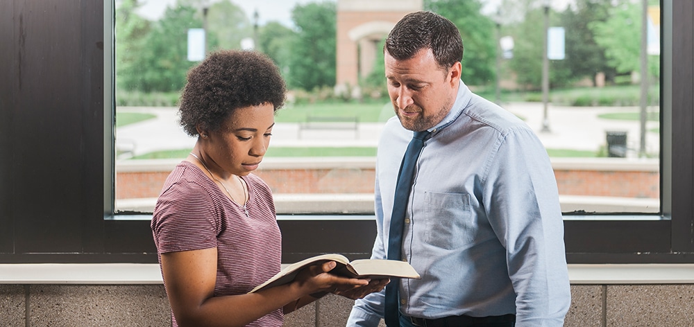 Dr. Jonathan Marko consults with an A.A. in Biblical Studies student at Cornerstone University.