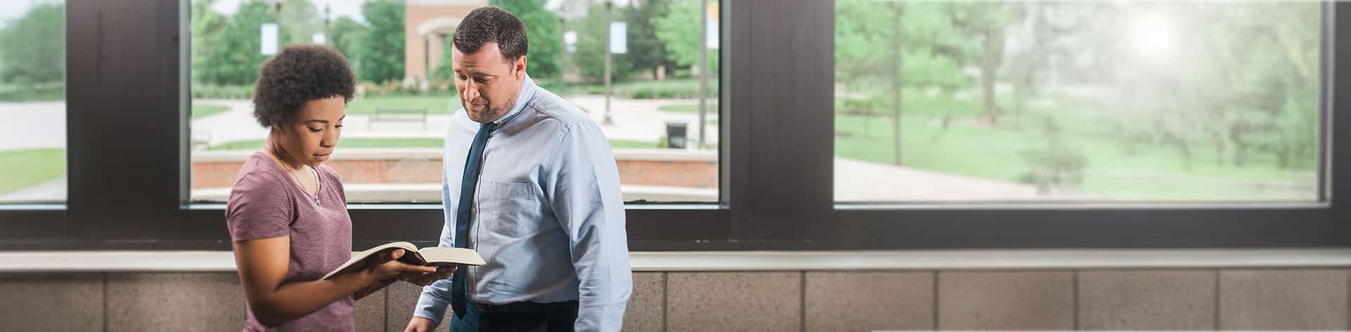 Dr. Jonathan Marko consults with an A.A. in Biblical Studies student at Cornerstone University.