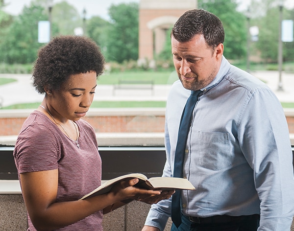 Dr. Jonathan Marko consults with an A.A. in Biblical Studies student at Cornerstone University.